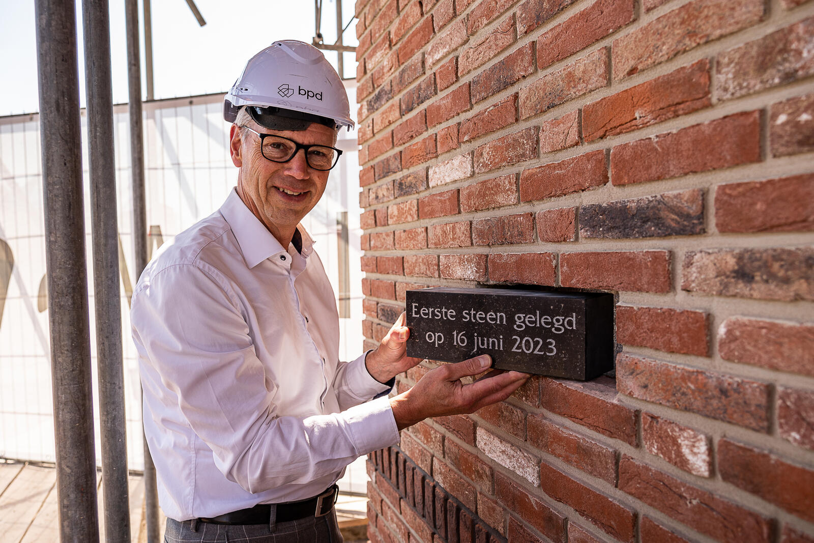 Albert Kerssies metselt steen in middenhuur woningen van BPD Woningfonds